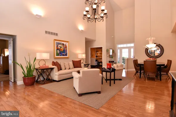 a living room with furniture a flat screen tv and a large window