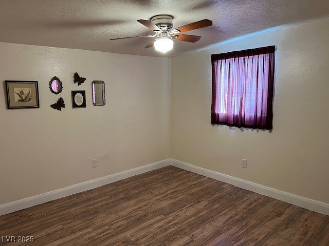 944 Main Street Panaca, NV 89042 - Photo 19 of 24 Empty room with ceiling fan, dark hardwood / wood-style floors, and a textured ceiling