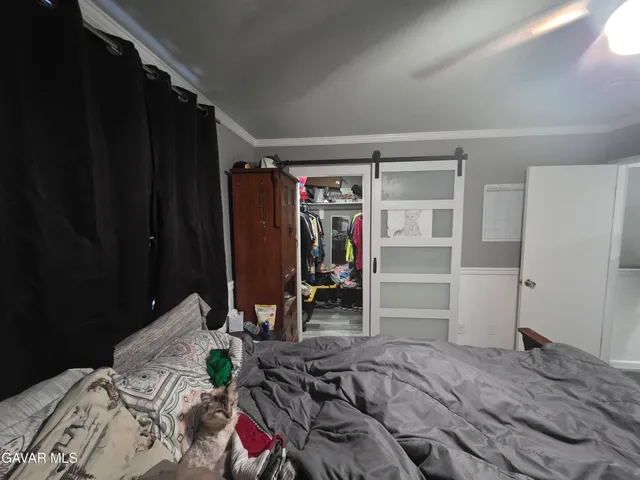 a bedroom with a bed table and closet