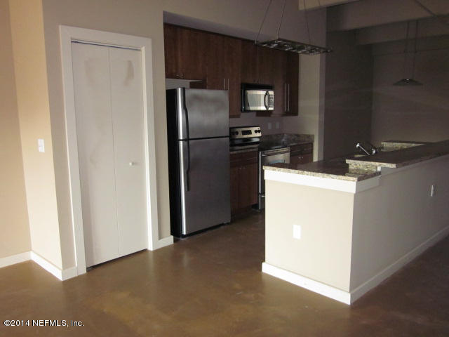 1661 Riverside Avenue, Unit 307 Jacksonville, FL 32204 - Photo 5 of 24 a kitchen with a refrigerator and a microwave