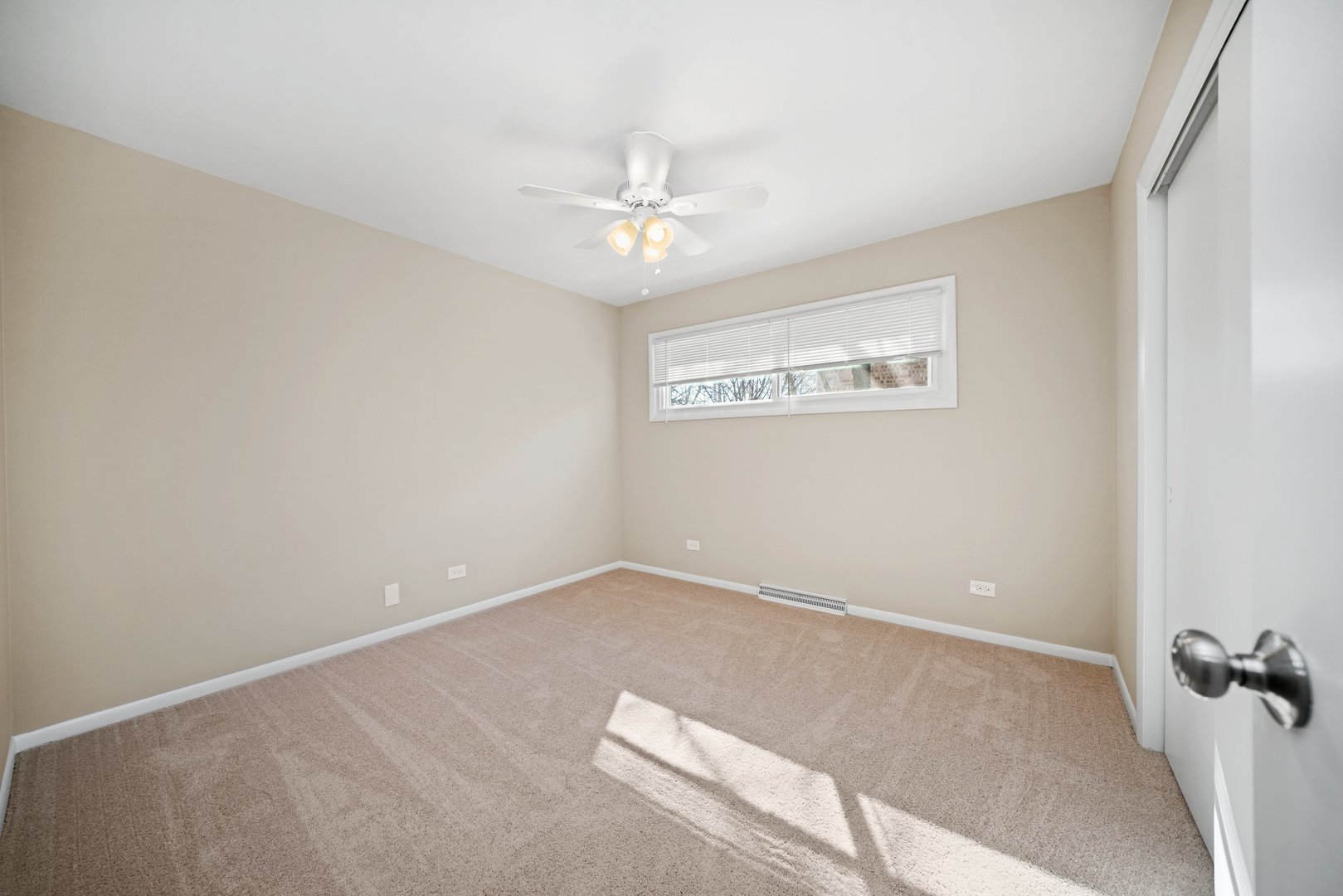 609 Delles Road Wheaton, IL 60187 - Photo 11 of 28 an empty room with a ceiling fan and a window