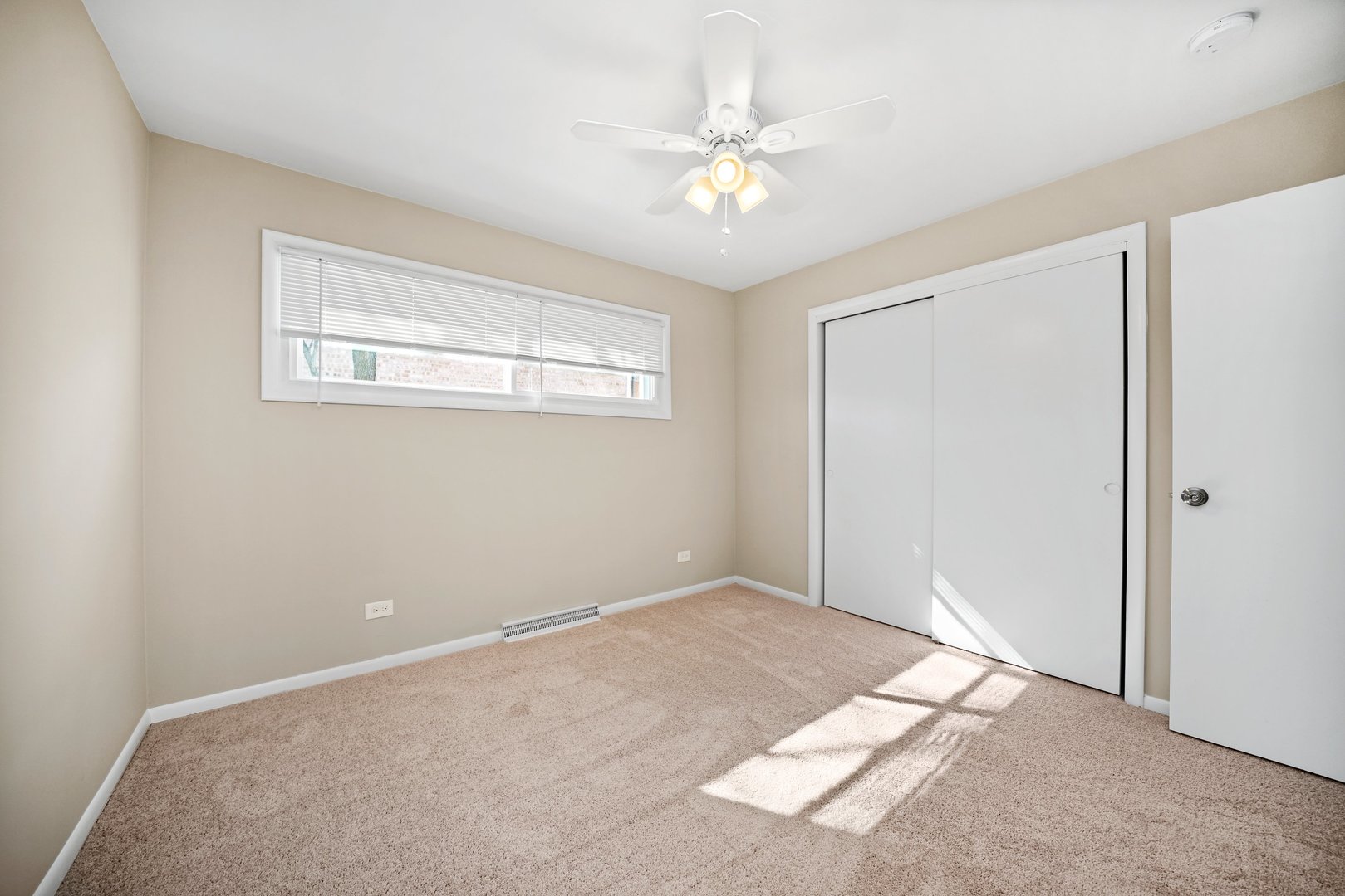 609 Delles Road Wheaton, IL 60187 - Photo 12 of 28 a view of a big room with windows and chandelier fan