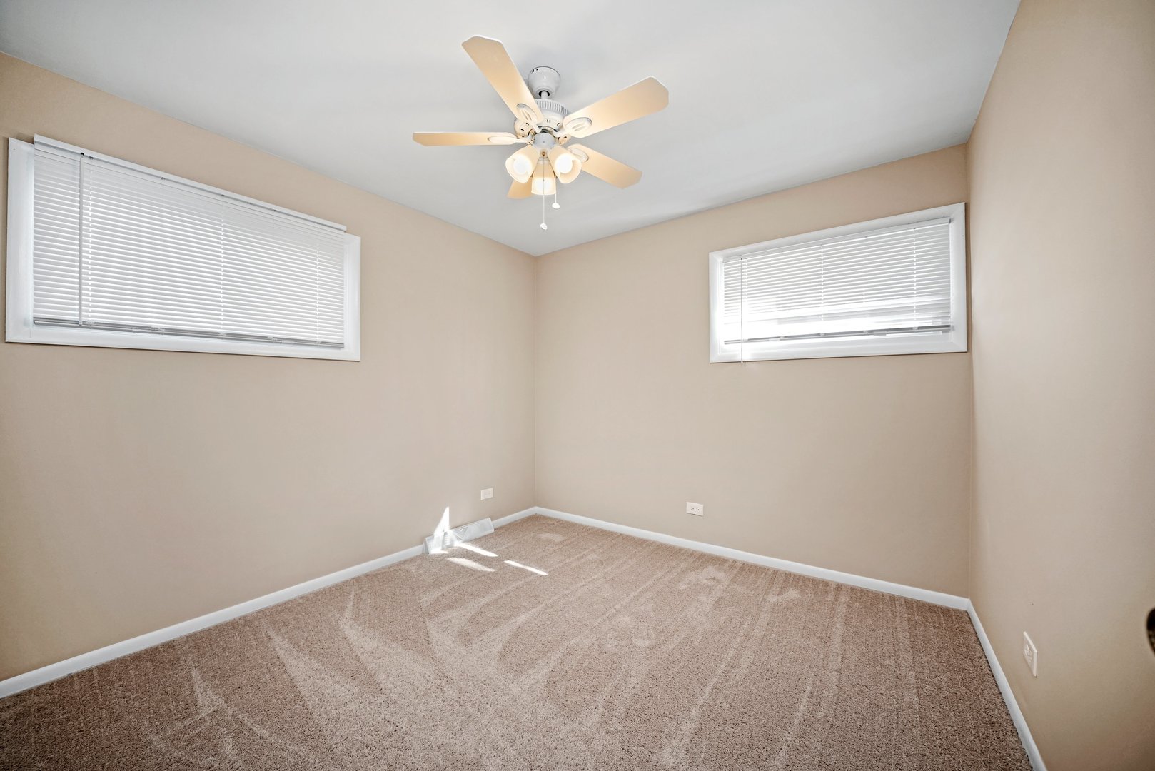 609 Delles Road Wheaton, IL 60187 - Photo 18 of 28 an empty room with a chandelier fan and windows
