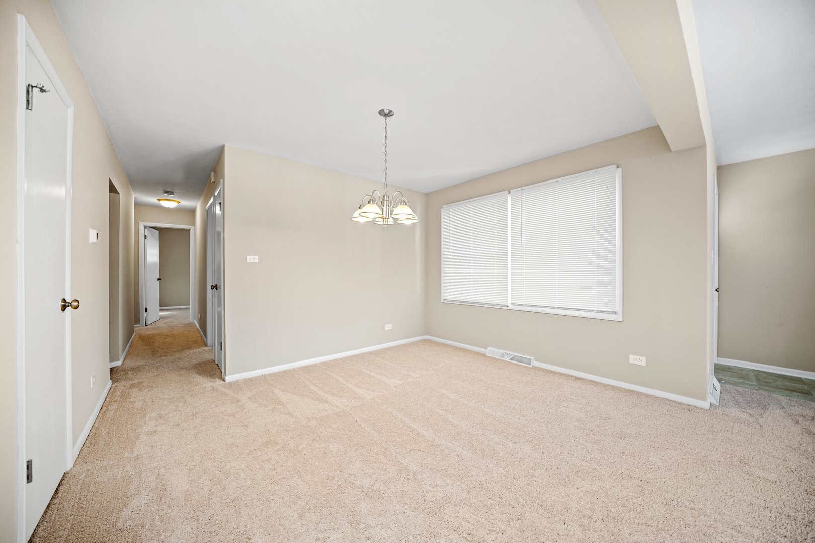 609 Delles Road Wheaton, IL 60187 - Photo 5 of 28 an empty room with chandelier fan and windows