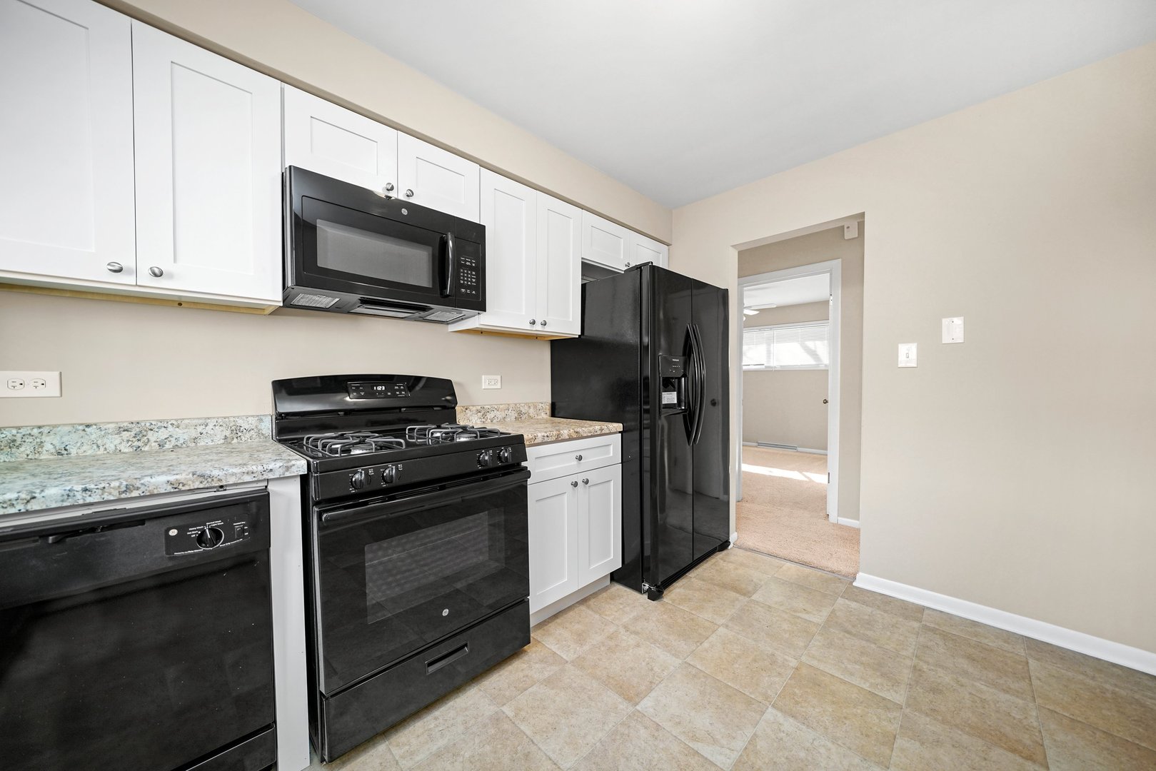 609 Delles Road Wheaton, IL 60187 - Photo 8 of 28 a kitchen with stainless steel appliances granite countertop a stove a refrigerator and a microwave