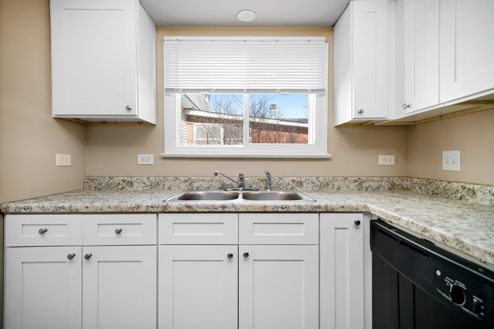 609 Delles Road Wheaton, IL 60187 - Photo 9 of 28 a kitchen with granite countertop white cabinets and a sink