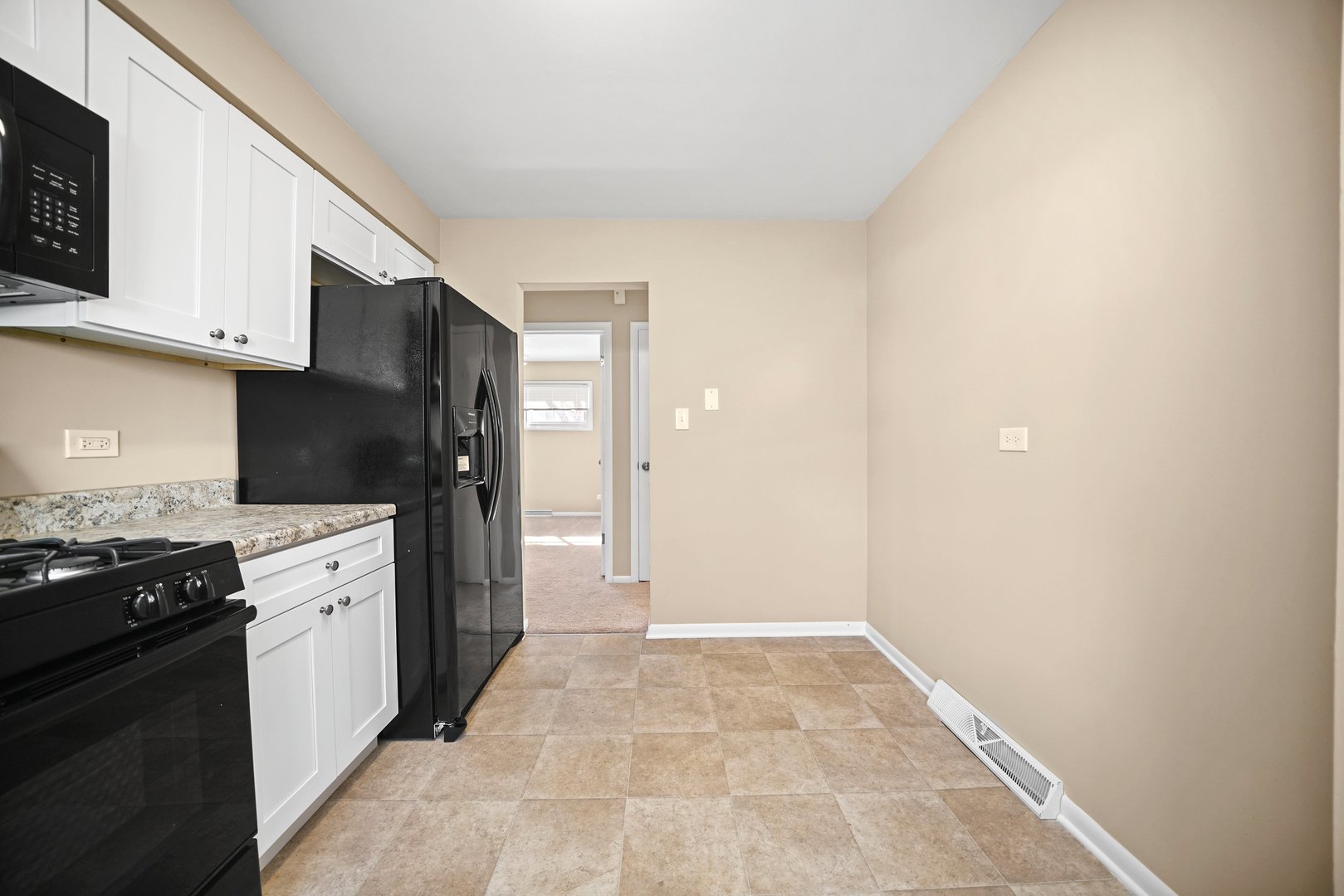 609 Delles Road Wheaton, IL 60187 - Photo 10 of 28 a kitchen with a sink and a stove