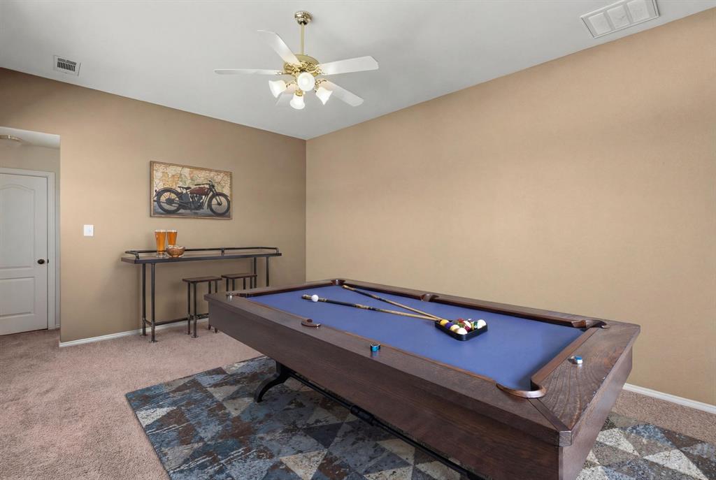 7517 Rodeo Drive Denton, TX 76208 - Photo 3 of 39 Upstairs game room virtually staged - includes built-in desks and a full bath.