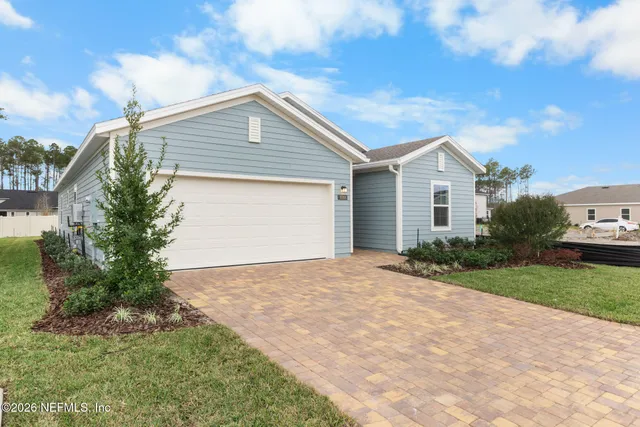 a view of backyard of house with green space