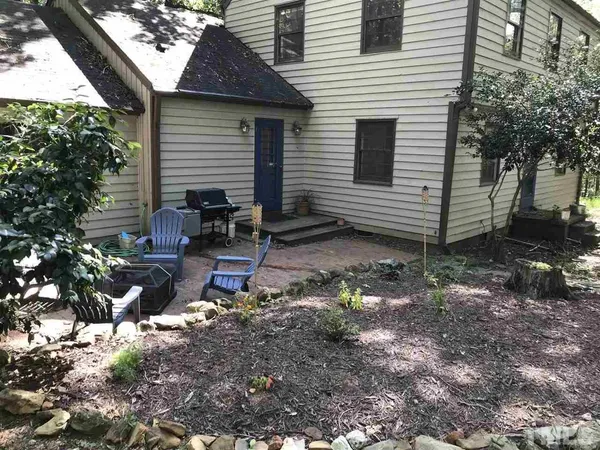 a backyard of a house with outdoor seating