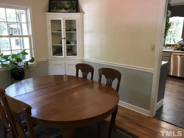 a kitchen with stainless steel appliances granite countertop a refrigerator a stove and a wooden floors