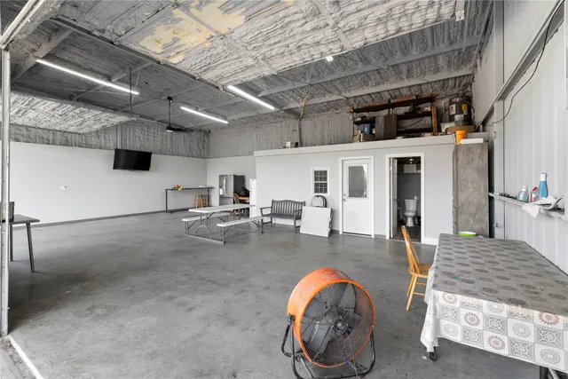 a view of a refrigerator in kitchen and a window