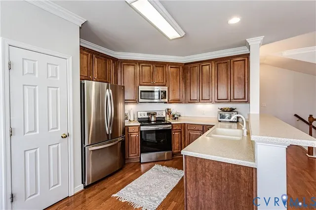a kitchen with granite countertop stainless steel appliances and wooden cabinets