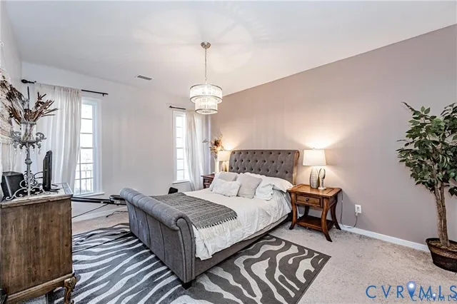a bedroom with bed and a potted plant