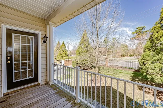 a view of a balcony with wooden floor and fence