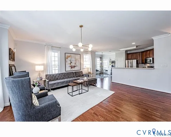 a living room with furniture and a chandelier