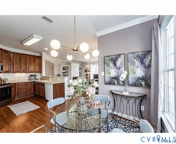a kitchen with a table chairs stove and cabinets