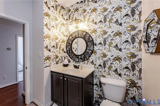 a bathroom with a sink toilet and mirror