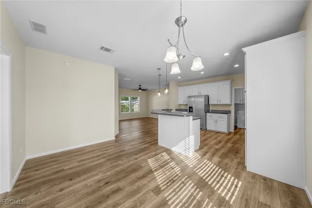 a view of kitchen and hall with wooden floor