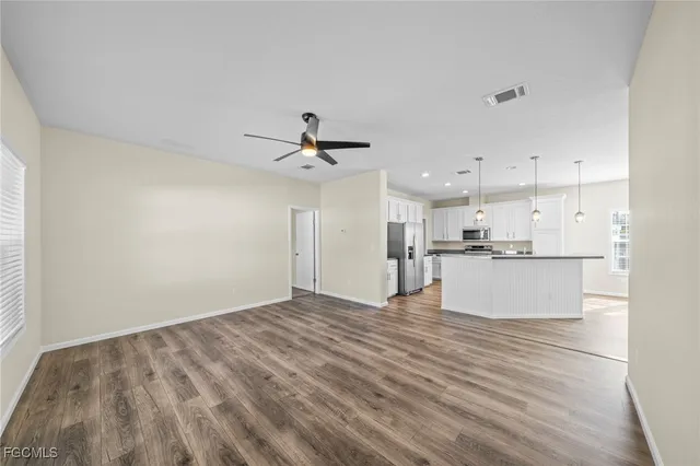 a view of kitchen with microwave and cabinets
