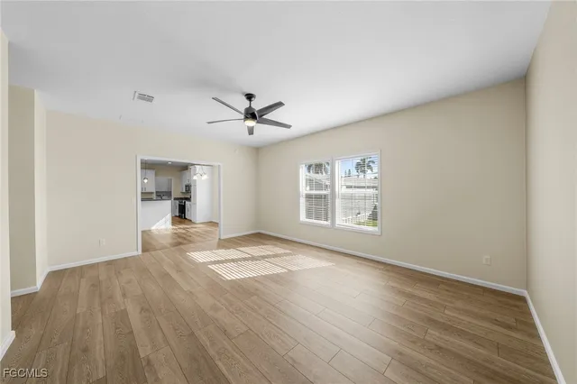 a view of empty room with wooden floor