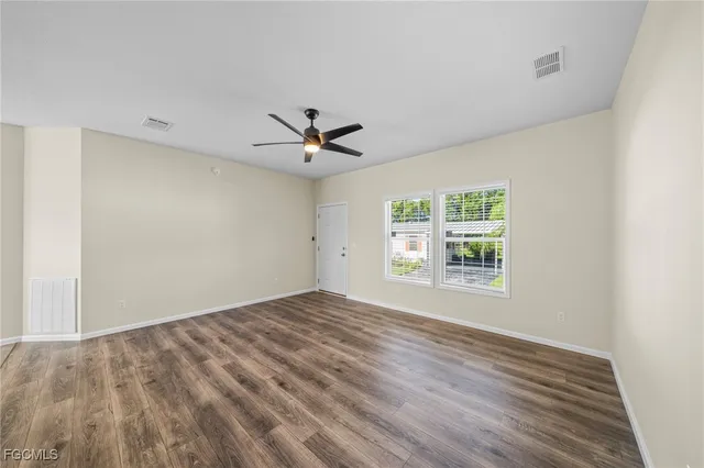 wooden floor in an empty room with a window