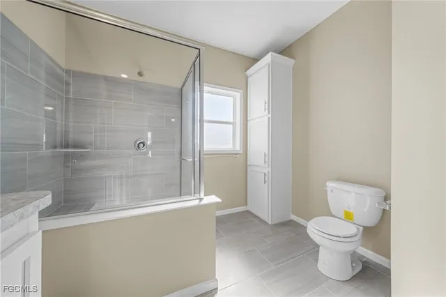 a bathroom with a toilet a sink and shower