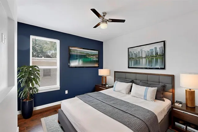 a bedroom with a large bed and a window