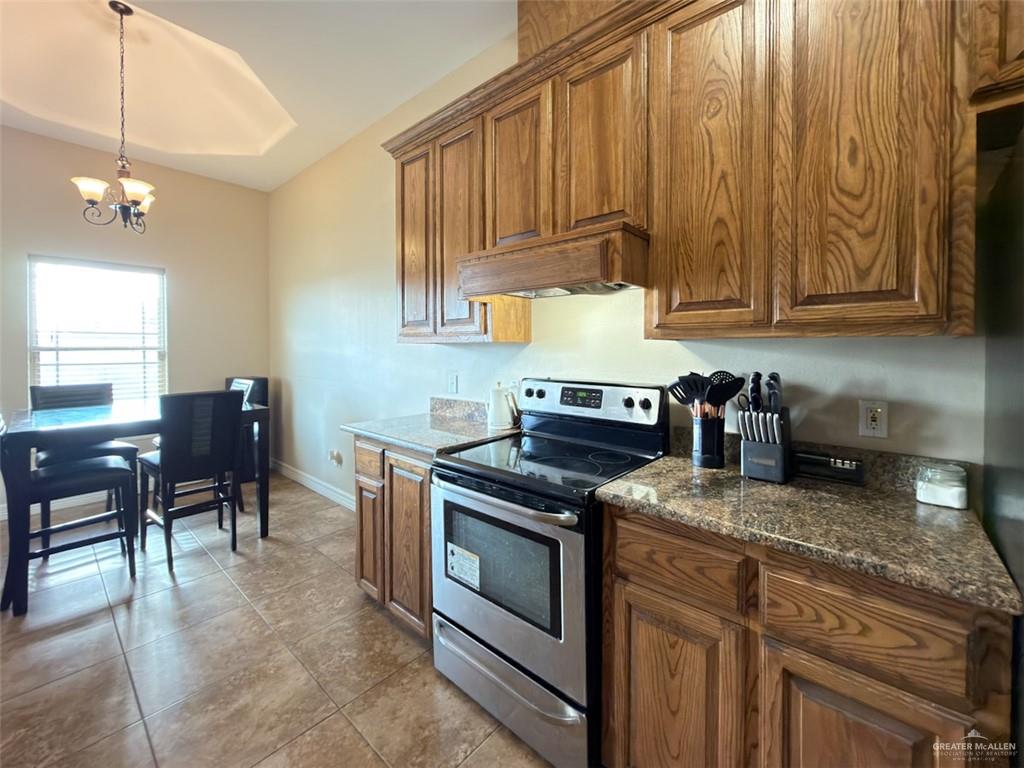 208 North 15th Street Hidalgo, TX 78557 - Photo 20 of 26 a kitchen with stainless steel appliances granite countertop a stove a sink dishwasher and cabinets with wooden floor
