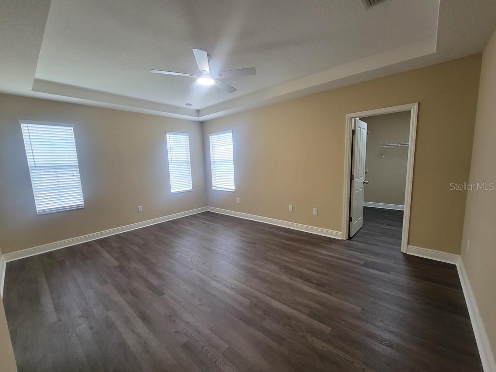 10418 Fenceline Road New Port Richey, FL 34655 - Photo 24 of 36 an empty room with wooden floor and windows