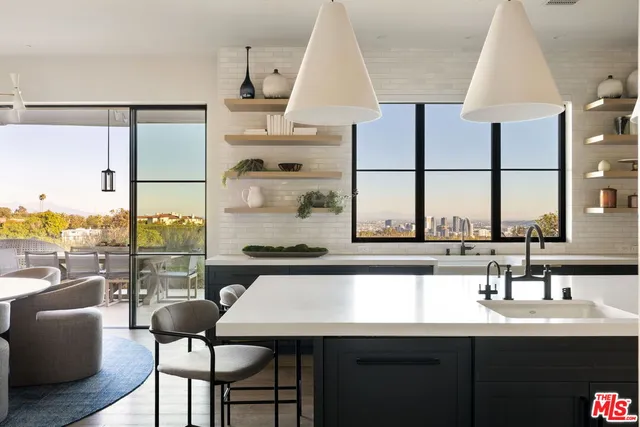a kitchen with a table chairs sink and cabinets