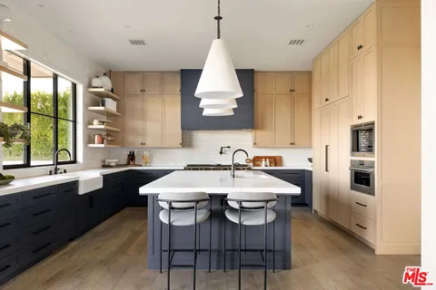 a roof deck with couches and potted plants