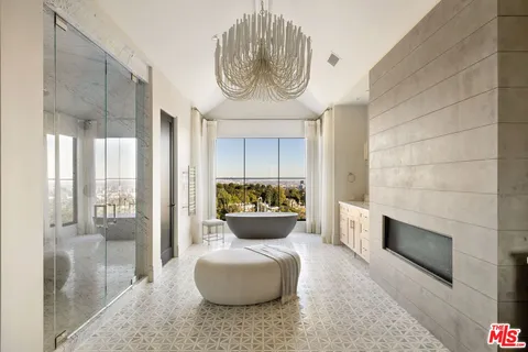 a spacious bathroom with a double vanity sink a mirror and a bathtub
