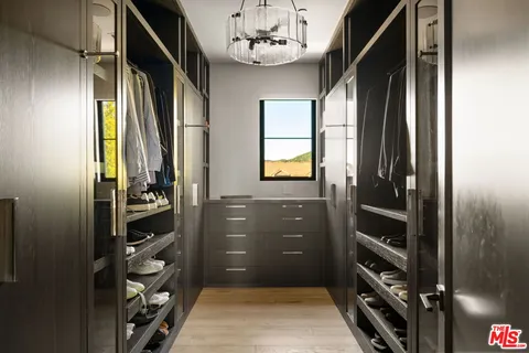 a bedroom with a bed and large window