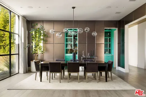 a living room with furniture a fireplace and a floor to ceiling window