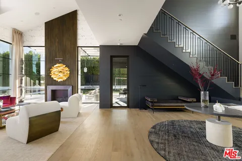 a living room with furniture and a floor to ceiling window