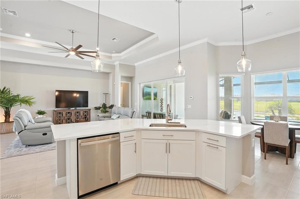 15027 Longs Lane Babcock Ranch, FL 33982 - Photo 17 of 50 a large white kitchen with a large island oven a sink and a large window