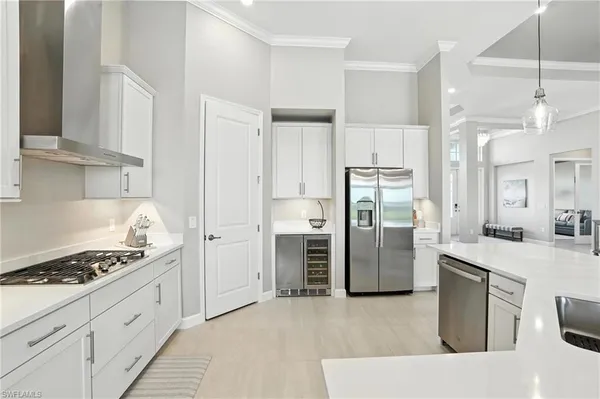 a kitchen with white cabinets and appliances