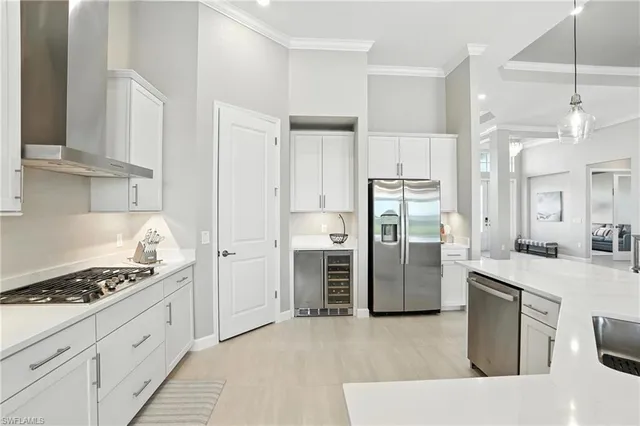 a kitchen with white cabinets and appliances
