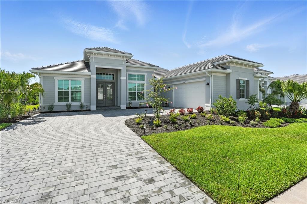 15027 Longs Lane Babcock Ranch, FL 33982 - Photo 2 of 50 a front view of a house with garden
