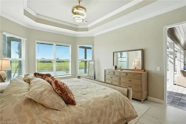 a bathroom with double vanity sinks a toilet a mirror and a bathtub