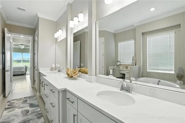a bathroom with a tub sink and mirror