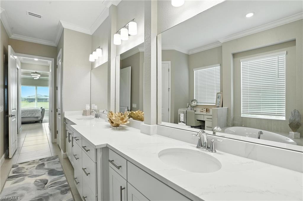 15027 Longs Lane Babcock Ranch, FL 33982 - Photo 30 of 50 a spacious bathroom with a double vanity sink and a mirror
