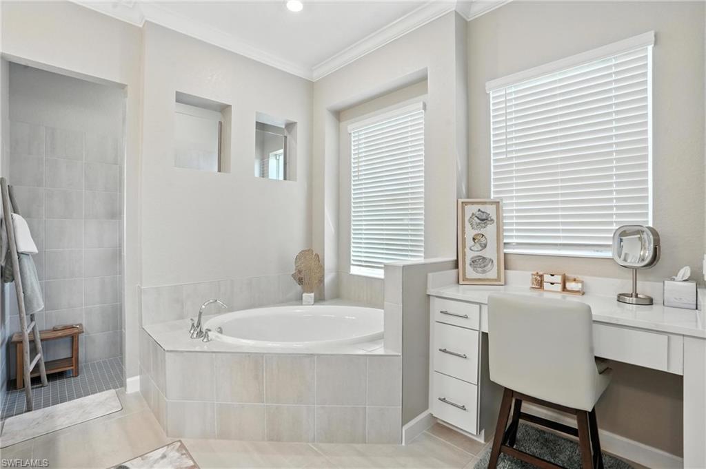 15027 Longs Lane Babcock Ranch, FL 33982 - Photo 31 of 50 a bathroom with a tub sink and mirror