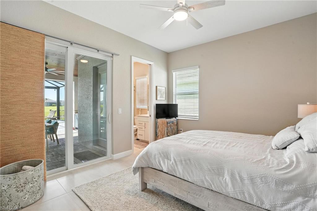 15027 Longs Lane Babcock Ranch, FL 33982 - Photo 32 of 50 a bedroom with a large bed and a chandelier