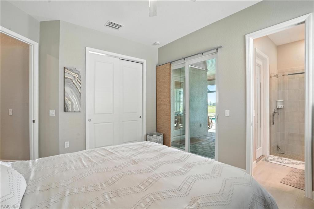 15027 Longs Lane Babcock Ranch, FL 33982 - Photo 34 of 50 a bedroom with a bed and a mirror