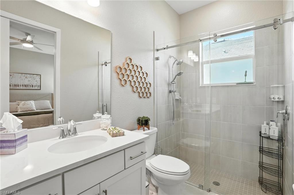 15027 Longs Lane Babcock Ranch, FL 33982 - Photo 35 of 50 a bathroom with a sink toilet double vanity and shower