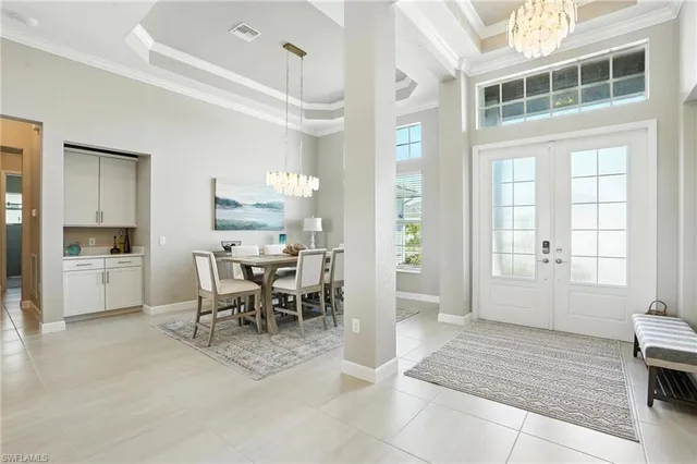 a dining hall with stainless steel appliances kitchen island granite countertop a table and chairs in it