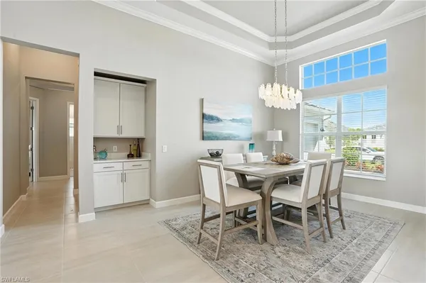 a dining room with furniture and window