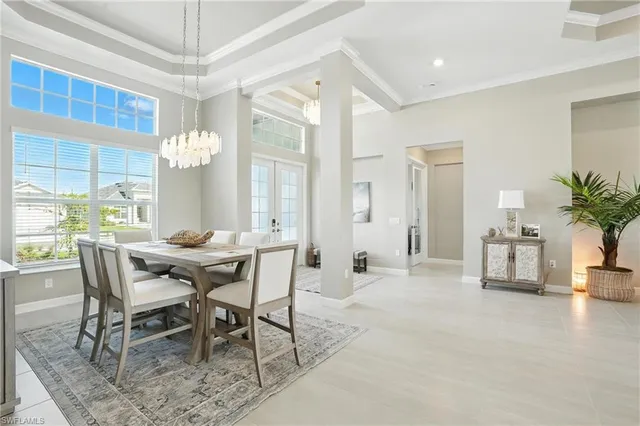 a view of a dining room with furniture and a chandelier